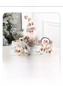 Detail of Christmas plush dolls showing soft knit texture and reindeer snowman designs