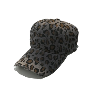 Detail shot of leopard print baseball cap featuring distressed edges and canvas texture