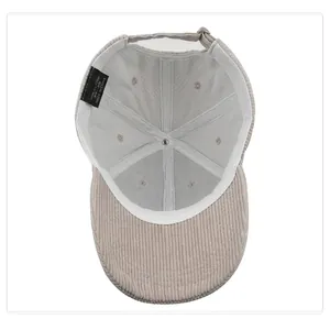 Inside view of a beige corduroy baseball cap with white lining and cotton label details