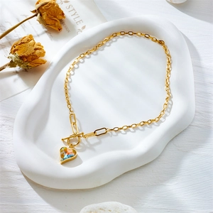 Golden toggle clasp chain necklace with faceted iridescent crystal heart pendant