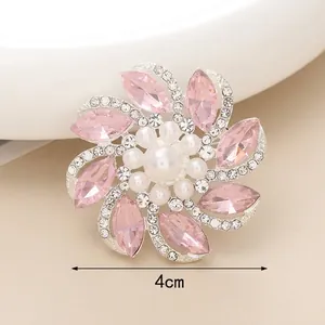 Macro shot of 4cm pink crystal flower accessory with large center pearl and silver base