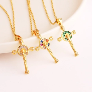 Detailed macro view of 18K gold plated cross pendants with colorful zircon inlay crystals