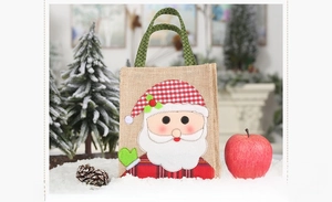 Detail of Christmas burlap gift bag with 3D Santa Claus applique and plaid handles