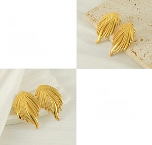 Detail of 18K gold-plated braided earrings with polished leaf texture on stone background