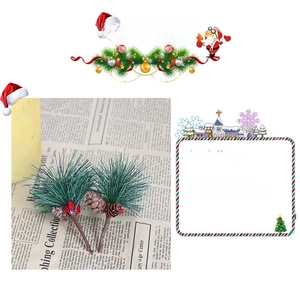 Detail of faux pine needles with small pine cones and red berries for Christmas decor
