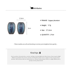 Detailed view of C-shaped earrings with blue gradient cubic zirconia and silver needles