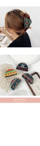 Detail of large bohemian acrylic hair claws with geometric patterns and ethnic prints