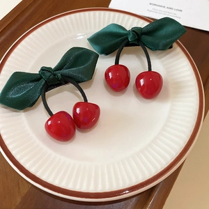 Sweet resin cherry hair clips with satin bow on a vintage plate for a stylish look