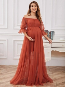 Detail of off-shoulder puff sleeves and layered tulle fabric on brick red maternity gown