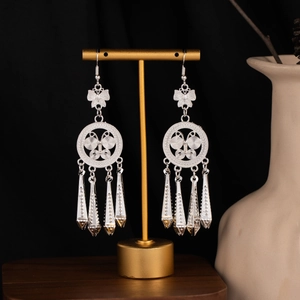 Detailed close-up of Bohemian butterfly earrings with silver hollow tassels and ethnic patterns