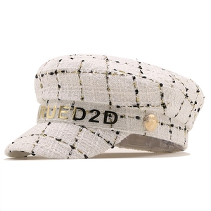 White tweed newsboy cap with gold thread and RUED2D lettered transparent trim