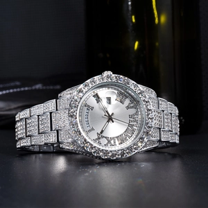 Detailed close-up of diamond-encrusted silver watch featuring date and weekday display