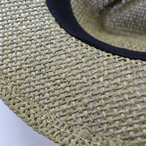 Close-up of the woven paper straw texture and black sweatband inside the sun hat