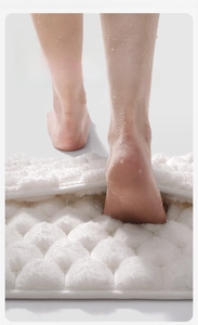 Detailed view of white memory foam bath mat featuring 3D absorbent texture and plush surface