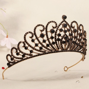 Detailed view of vintage gold metalwork and black rhinestones on a queen crown