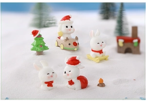 Miniature resin Christmas bunnies in red hats with sleigh and snow scene decor