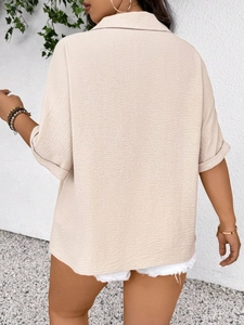 Back view of women's plus size apricot short sleeve blouse in textured pleated fabric