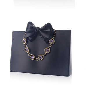Detailed shot of golden heart chain bracelet with purple round zircons on creative display