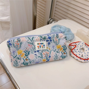 Detail of floral canvas pencil case with bunny patterns and a BEST heart label