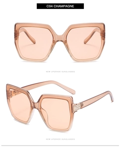 Detail of champagne cat eye sunglasses with rhinestone accents on the temples