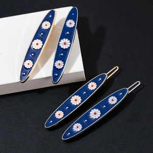 Elegant navy blue enamel daisy hair clips in gold and silver finish set of four