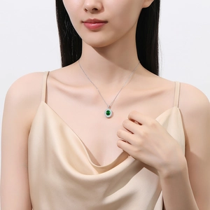 Elegant S925 silver necklace with emerald pendant and diamonds worn by a model