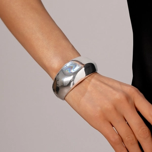 Detailed macro shot of the polished silver bone cuff bracelet with ergonomic organic curves