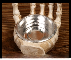 Detailed view of skull hand holder with corrosion-resistant metal tray and smooth edges