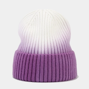 Detailed view of the purple and white tie-dye gradient rib-knit texture on a beanie
