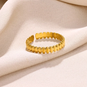 Macro shot of 18k gold plated stainless steel open ring with vertical oval hollow patterns