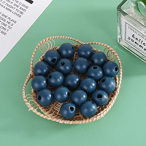 Deep blue 16mm painted wooden round beads in a woven basket for DIY jewelry making