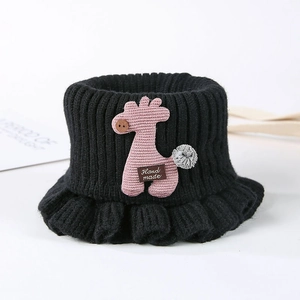 Detail of black knit bucket hat with pink giraffe patch and handmade label for kids