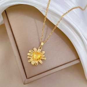 Champagne gold sunflower pendant necklace with yellow crystal on elegant silk backdrop