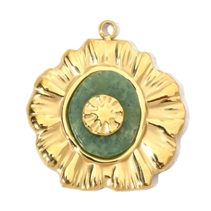 Detailed view of oval gold flower pendant with green stone and center floral inlay