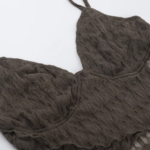 Macro detail of dark brown ribbed knit camisole with deep V-neck and slim straps