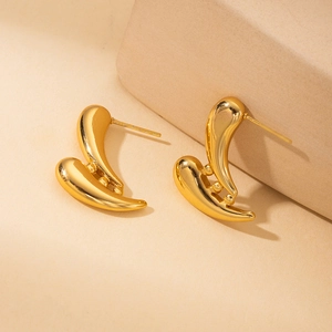 Detailed view of 18K gold-plated irregular streamlined earrings with metal bead accents