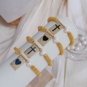 Bohemian gold stretch bracelets with pearls and sparkling cross and heart charms