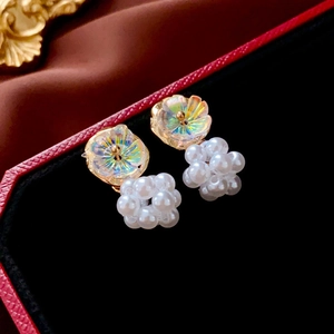Elegant iridescent flower earrings with clustered pearls on black velvet jewelry tray