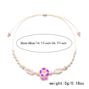 Detail of adjustable bohemian necklace with shell, wooden beads and Frangipani flower