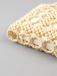Handmade cream hollow wooden bead bag with a beige canvas liner for beach vacation