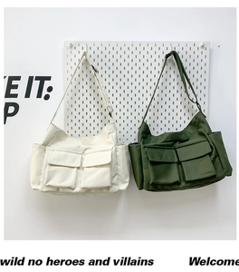 Canvas messenger bag set featuring large front flap pockets and adjustable wide straps