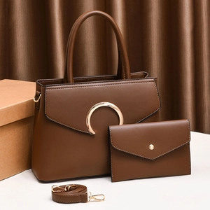 Detailed set of brown leather handbags featuring a large golden metal buckle and accessories
