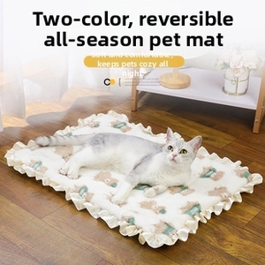 Detailed view of reversible pet blanket with cute bear print and frill edge design