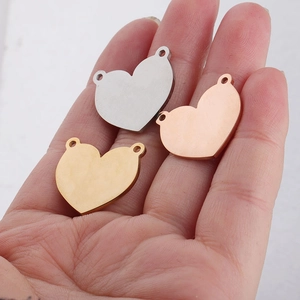 Detailed comparison of gold, silver, and rose gold heart pendants held by hand
