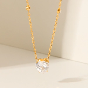 Detailed close-up of 18K gold plated heart necklace featuring clear cubic zirconia gems