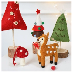 Detailed view of handmade wool felt reindeer and Christmas trees with natural wood bases