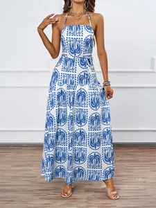 Detail of halter neck design and blue white palm leaf print on beach maxi dress