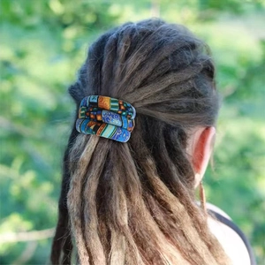 Ethnic blue fabric bendable wire hair tie worn in a high ponytail bun outdoors
