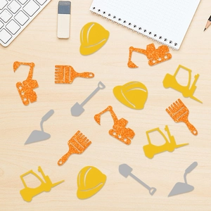 Construction party confetti with glitter excavators and helmets on a wooden table