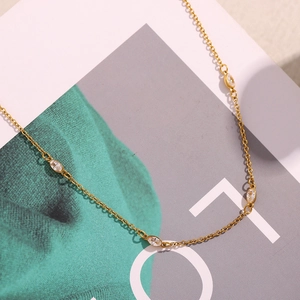 Detailed close-up of 18K gold plated necklace featuring sparkling marquise cut cubic zirconia
